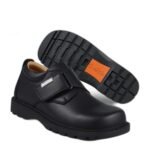 Boys' black school shoes with a single wide velcro strap and a cushioned orange-trim sole