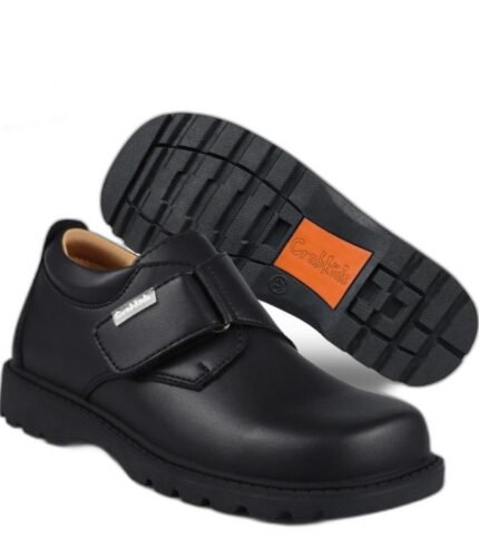 Boys' black school shoes with a single wide velcro strap and a cushioned orange-trim sole