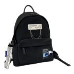 Kids' black nylon school backpack with a woven label and chain detail