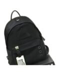 Kids' black nylon backpack with a neon yellow luggage tag